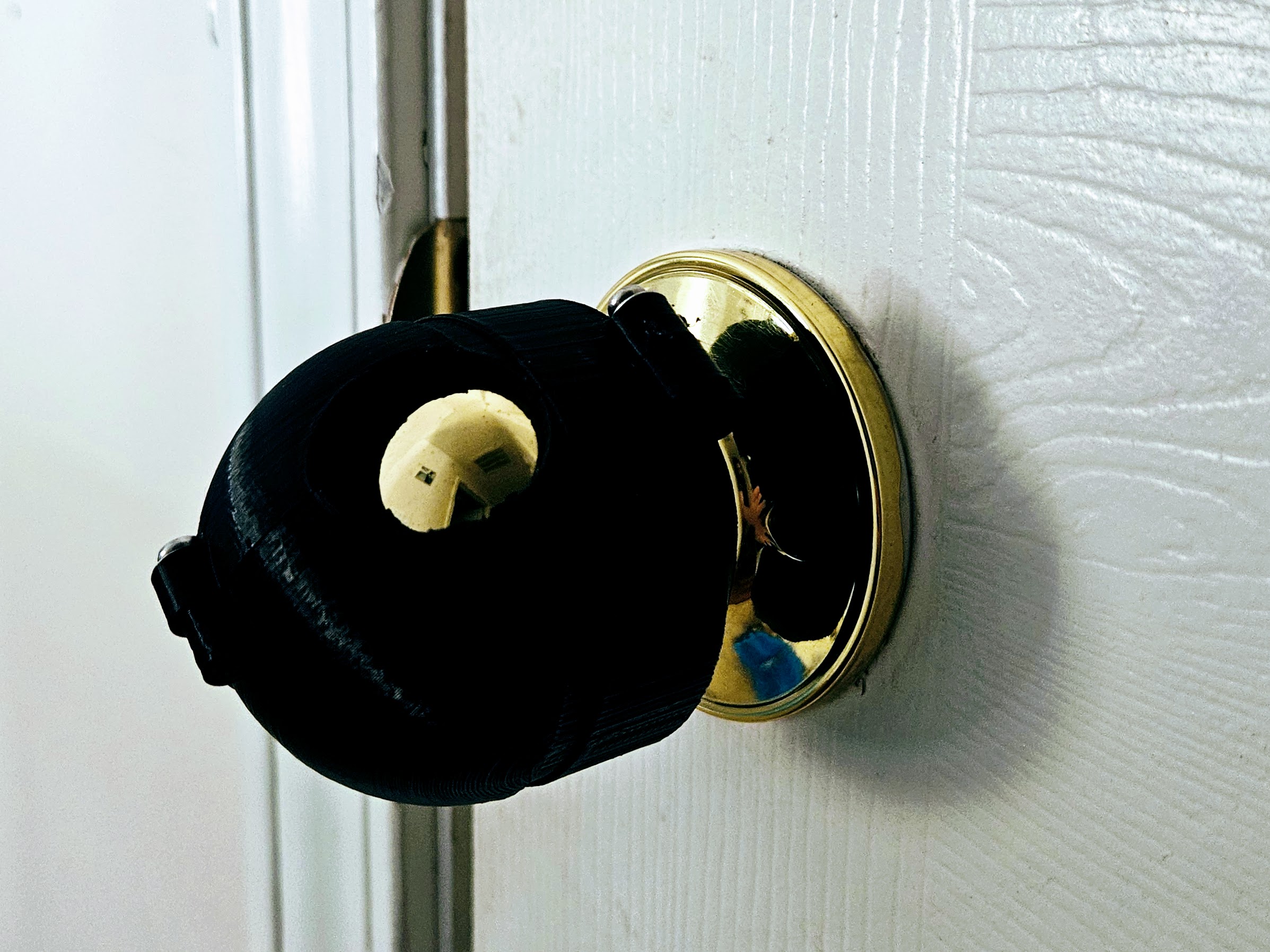 Printed door knob cover on an actual door knob
